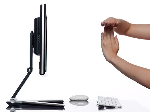 Human relationship with computer communication timeout concept A pair of hands in front of a computer screen