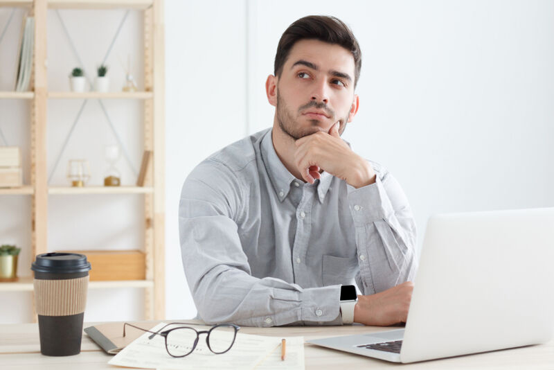 A young business man thinking about an Electronic Mailing List Young business man thinking what is an electronic mailing list