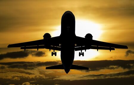 A photo of an aeroplane and sunset