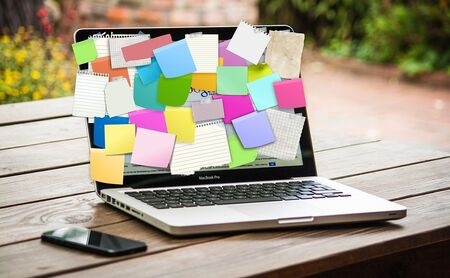 A laptop covered in post-it notes