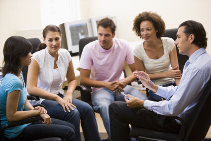 A photo of a group of people discussing