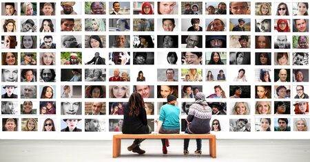 A group of people looking at photos of people