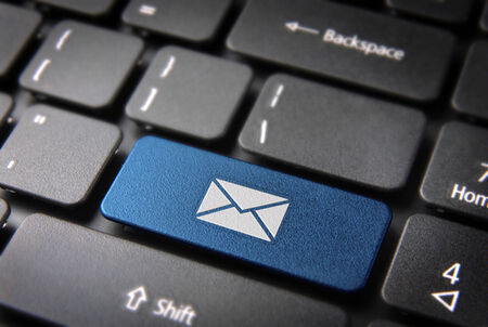 A photo of a keyboard with one key blue with an envelope