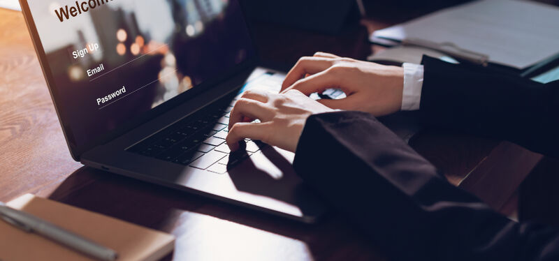An example of typing on a laptop to use a secure mailing list Hands typing on a laptop using a secure mailing list